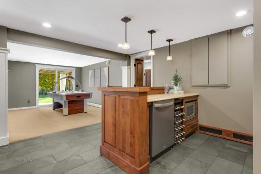 Enjoy snacks while you binge your favorite movie marathon, clean up is easy with a dishwasher in the bar area.