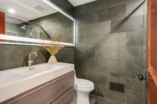 Enjoy a second 3/4 bathroom in the lower level just off the sports court - the sellers call it the "pool bath."