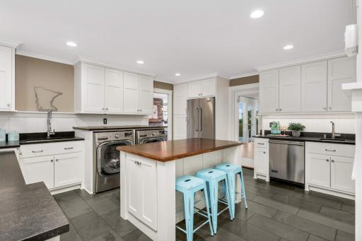 This is what laundry room dreams are made of! Enjoy great storage just off the kitchen for those Costco trips. You'll appreciate the second dishwasher and refrigerator as well. There is incredible storage and a utility sink.
