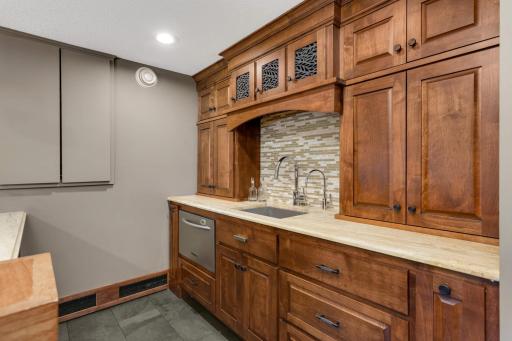 This bar features gorgeous custom millwork and functional storage solutions.