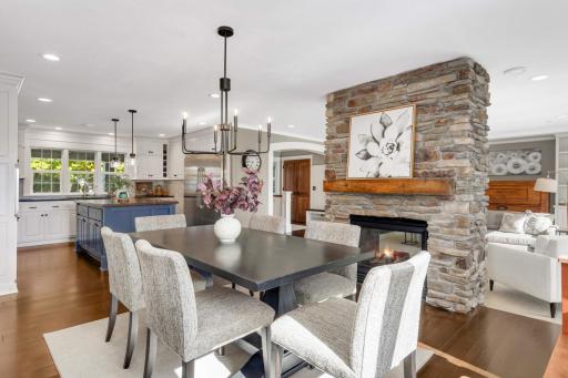 The dining room features a sliding door out to the screened porch, beautiful hardwood floors and designer fixtures.