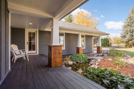 The covered front porch is so charming, and the side door that leads into the mudroom will come in handy. Don't miss the koi pond.