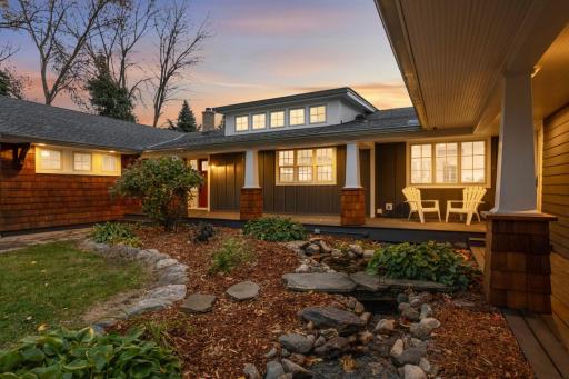 The front of the home features a koi pond, covered front porch, and welcoming curb appeal.