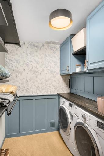 Enjoy a second laundry area in the home, complete with designer touches and a place to fold laundry.