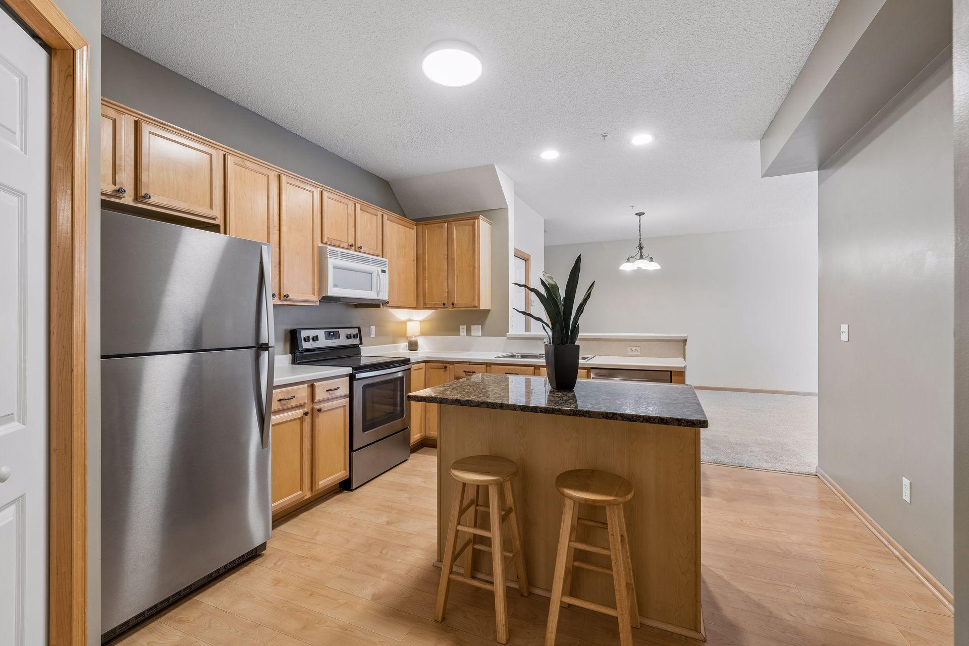 The nicely appointed kitchen features a center island along with an eat at breakfast bar.