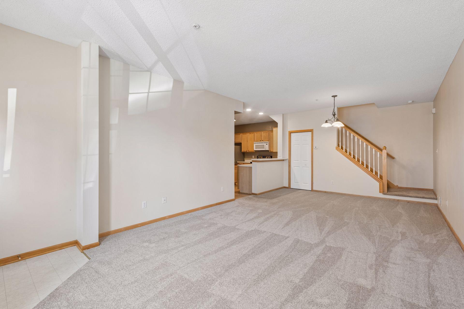 The spacious living room blends into the informal dining area and is open to the kitchen. The entire home recently had all new carpet and pad installed.