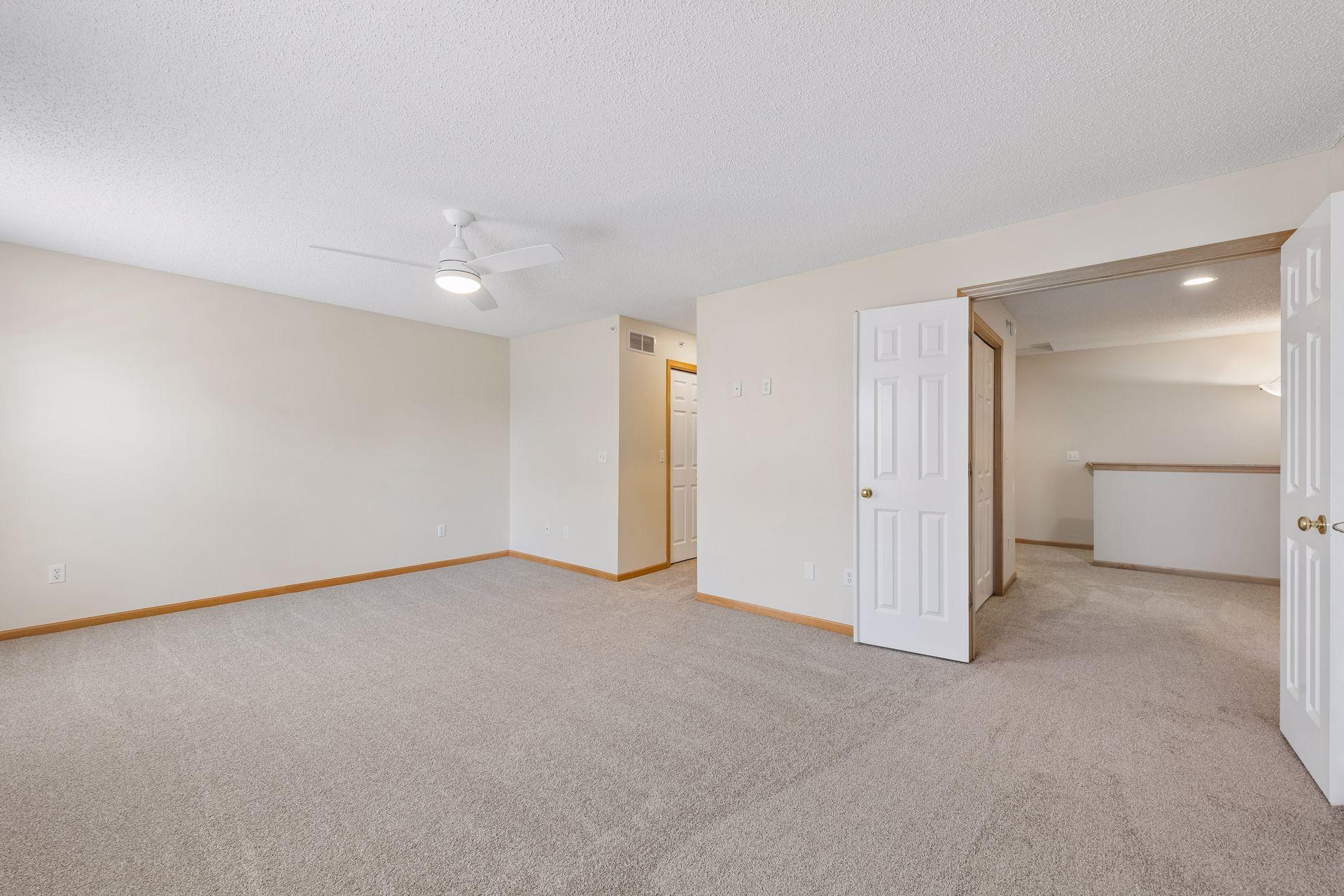 Double doors frame the primary suite just off the loft area.