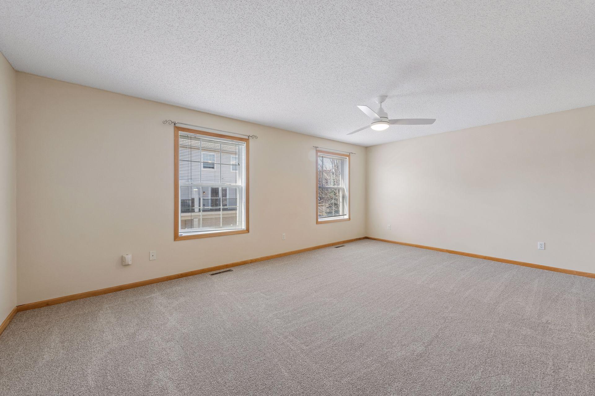 The spacious primary bedroom features two closets and access to the full bathroom with separate tub and shower.