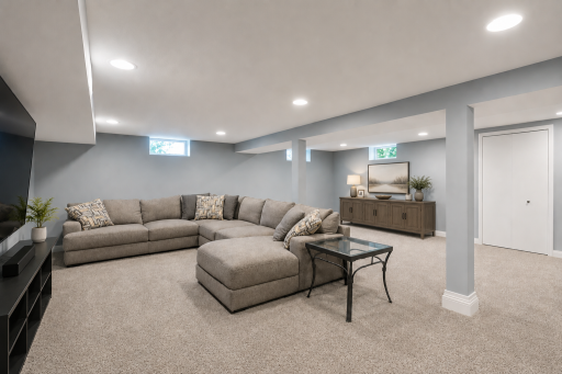 The spacious basement offers plenty of room for entertainment or to get cozy for a movie night in! The hutch at the back of the room has been virtually added.
