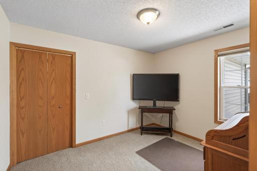 The spacious second bedroom features a sizable walk-in closet. This room can also serve as a convenient home office.
