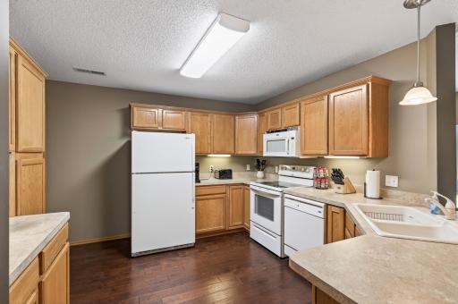 The kitchen features classic white appliances and plenty of countertop and cabinet space for all of your everyday needs.