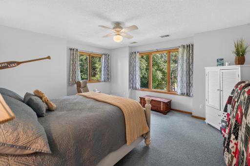 3rd bedroom with windows looking to lake and side of home.