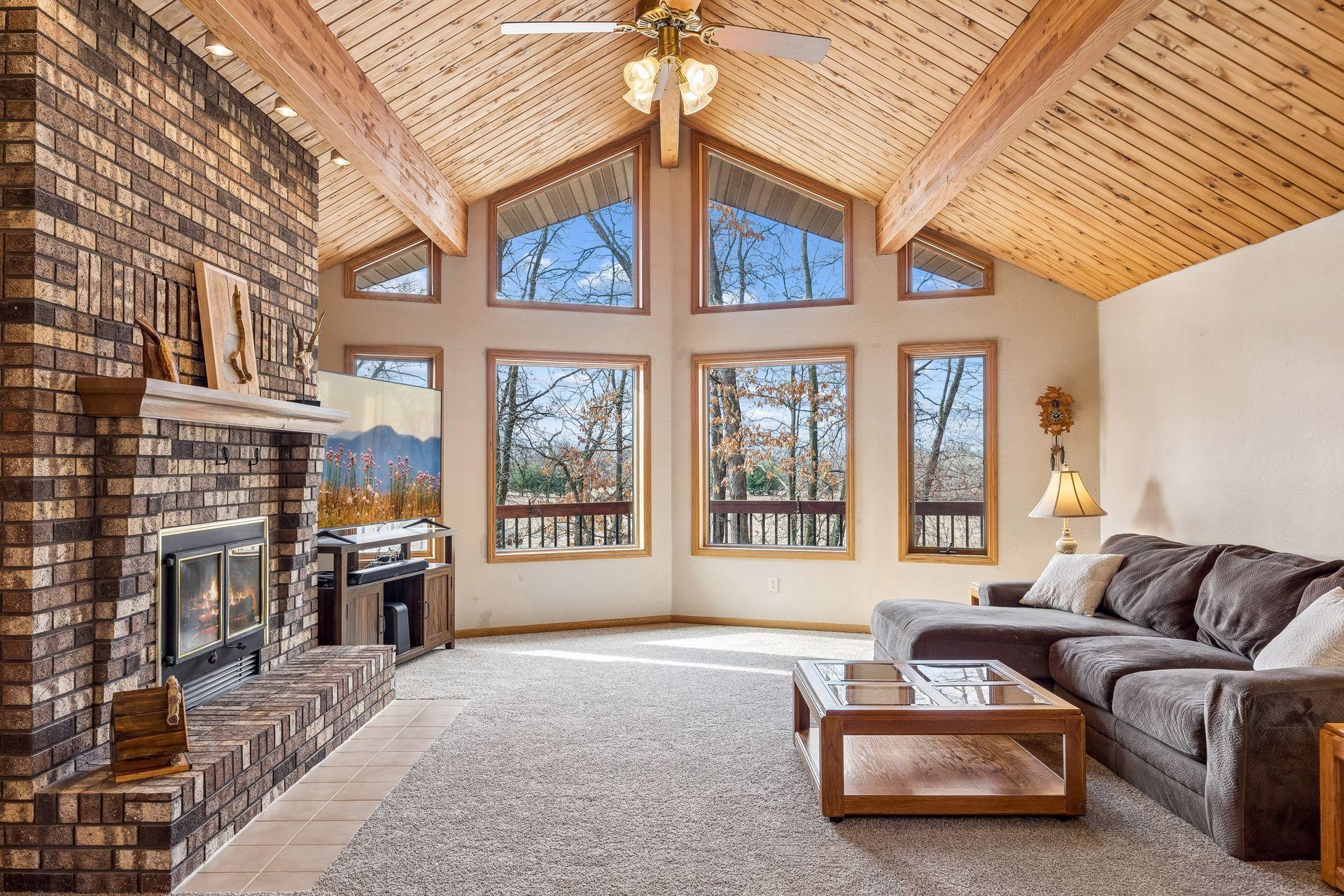 Beautiful brick fireplace anchors the living room.