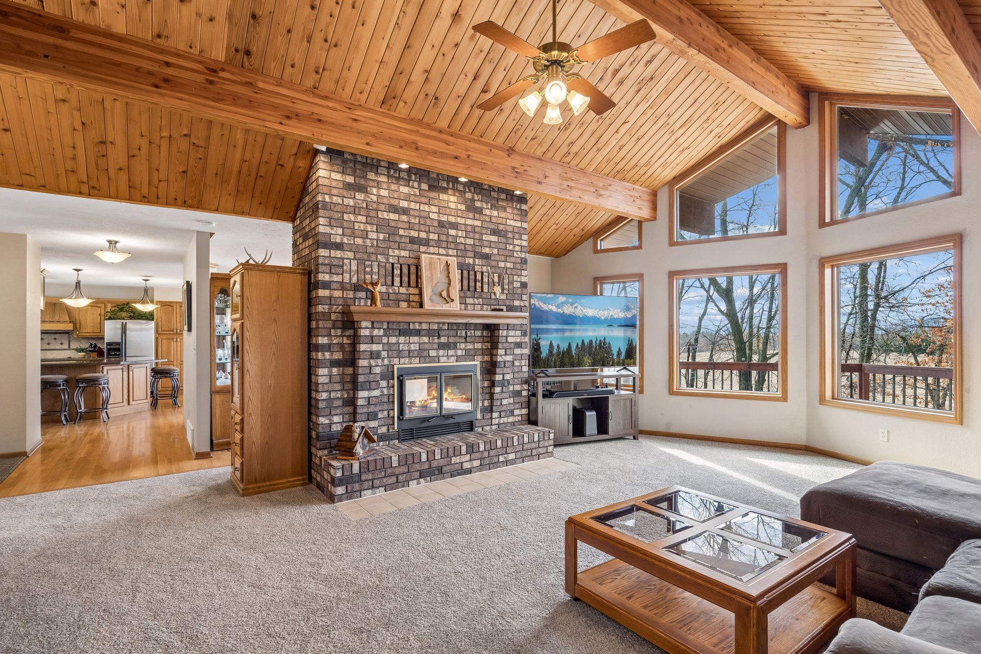 Double-sided wood-burning fireplace shared between the living and dining rooms, with incredible views beyond.