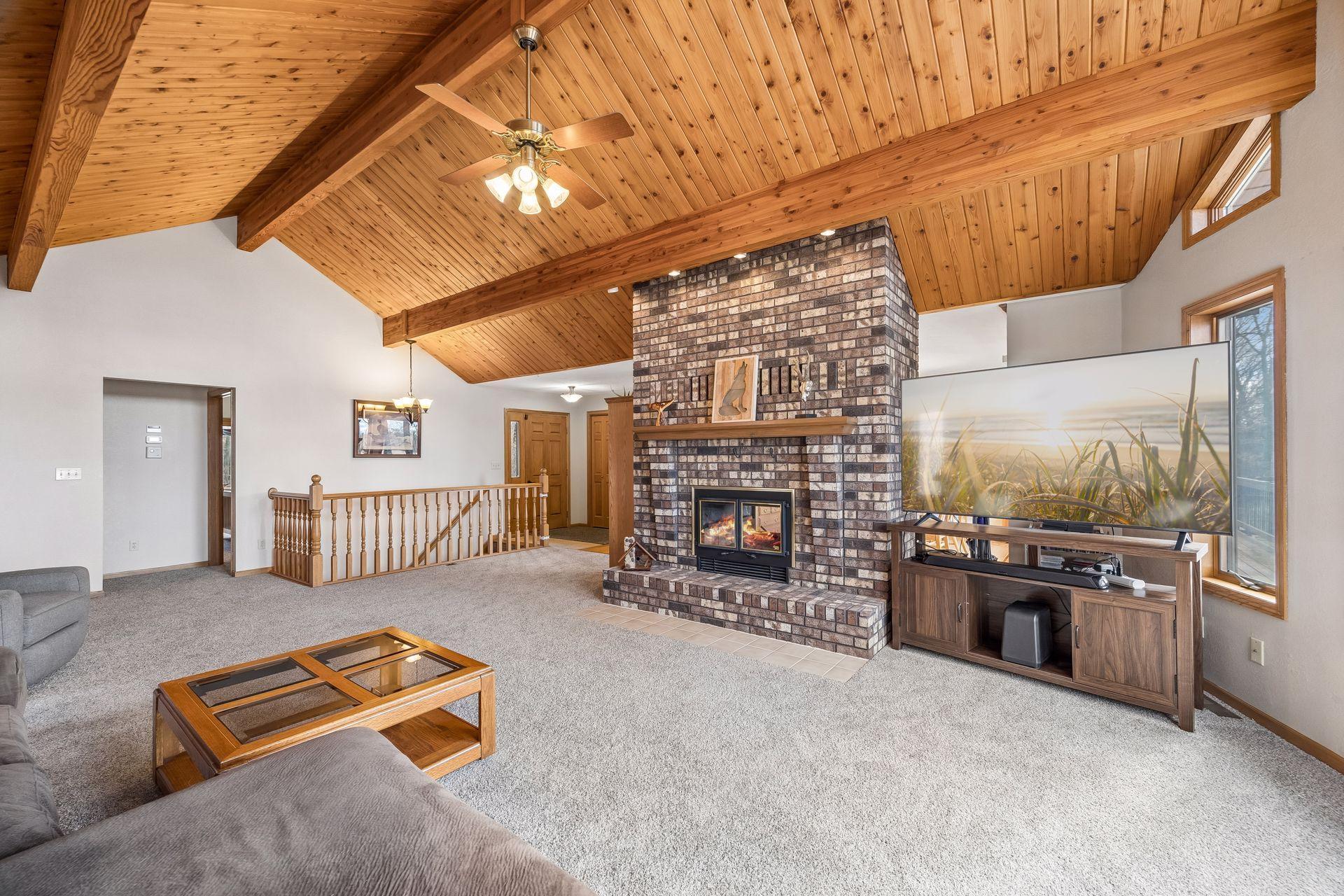 Light-filled living room with windows framing the natural surroundings.