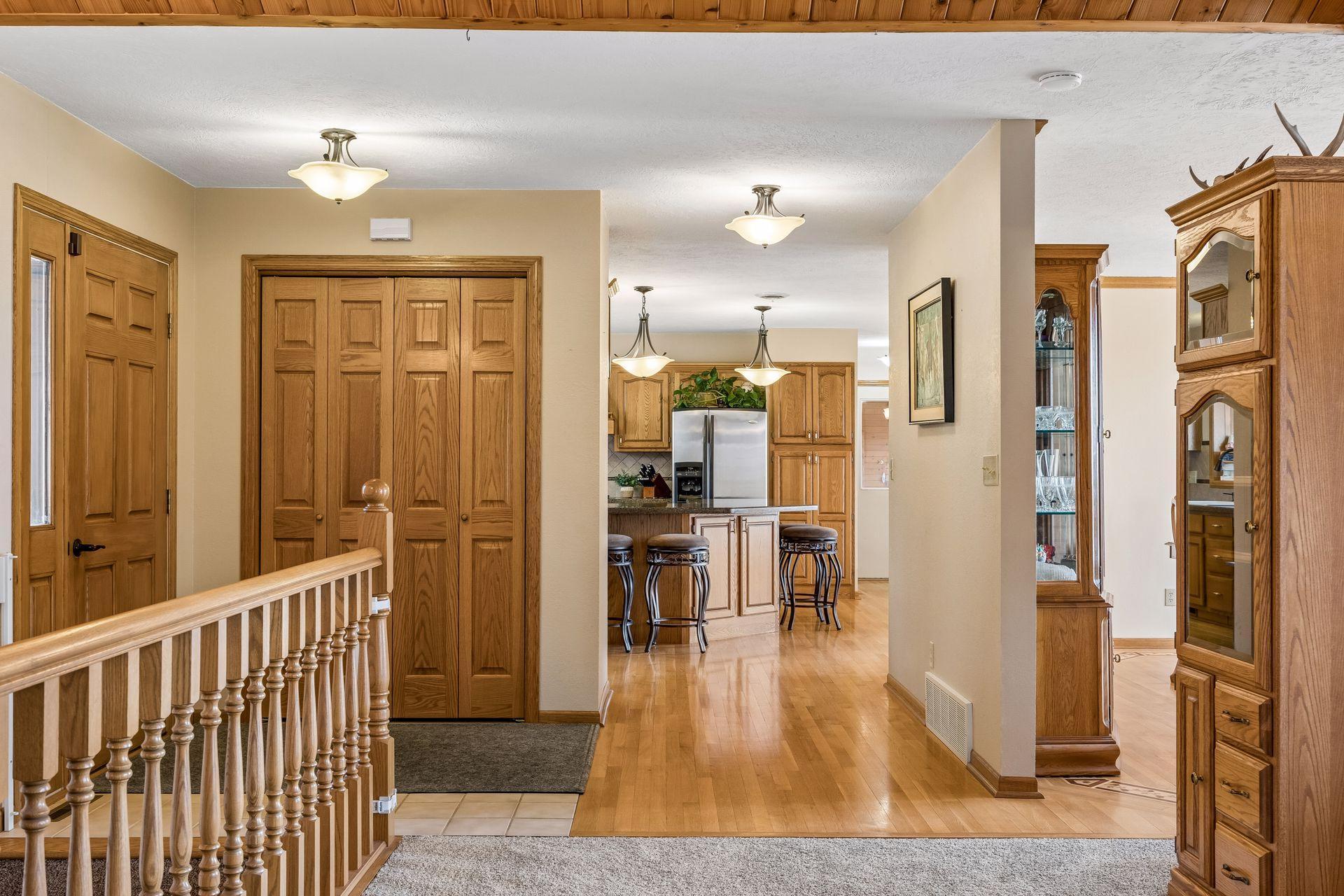 Kitchen and dining area with warm finishes and beautiful flooring.