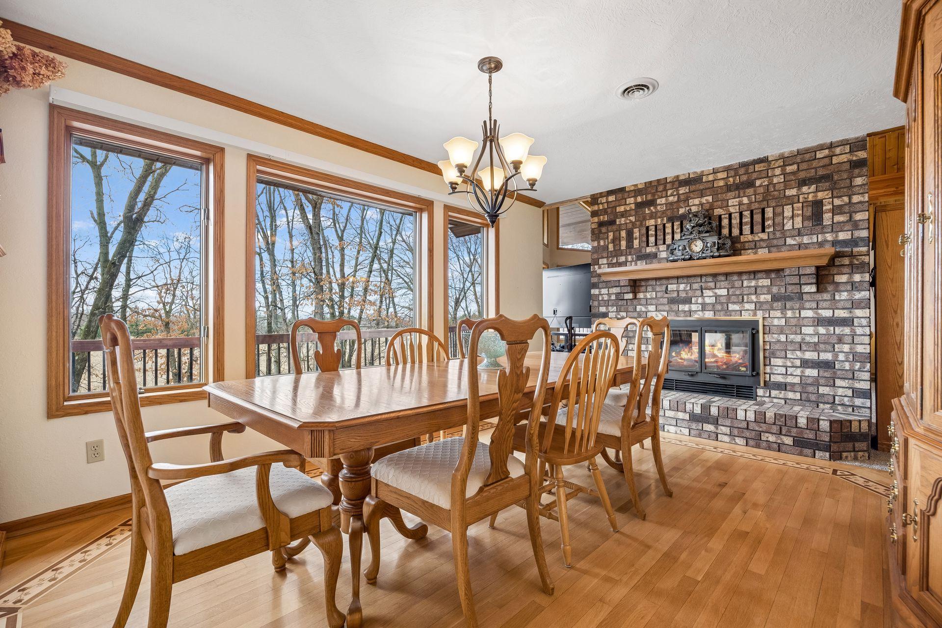 Expansive dining room with a cozy wood-burning fireplace.