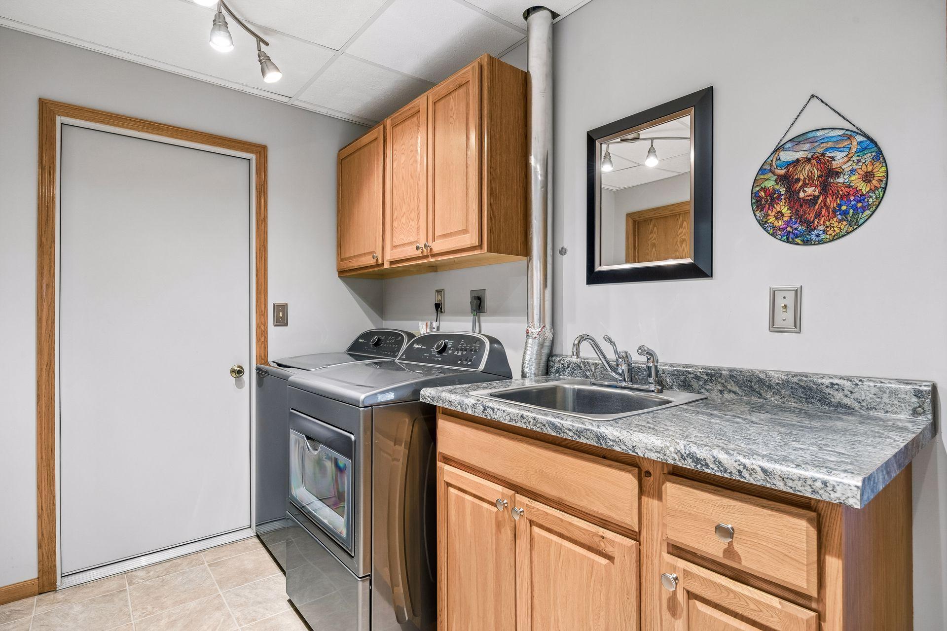 Large lower level laundry room with plenty of space.