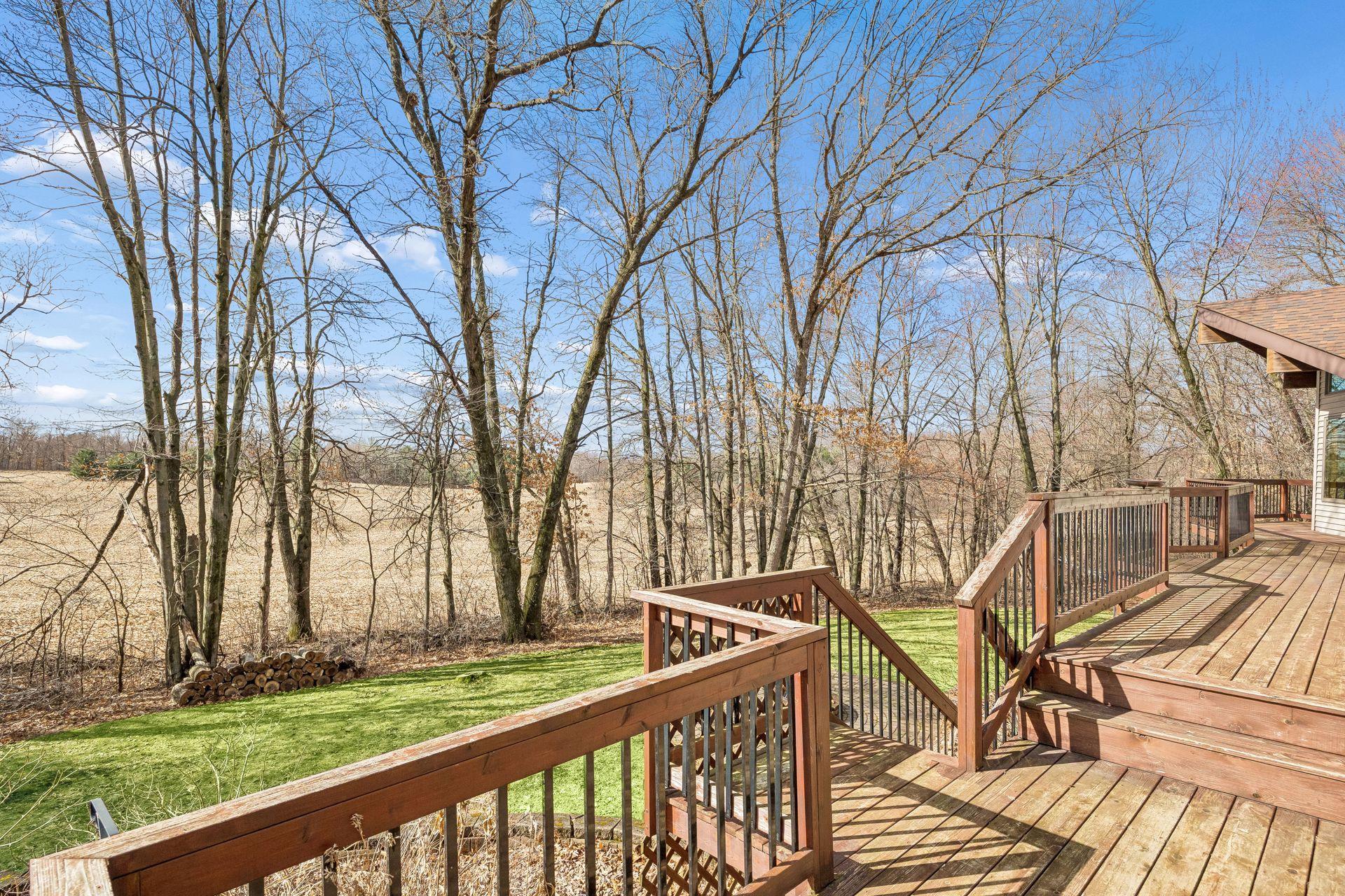 Stairs lead from the deck down to the patio below.