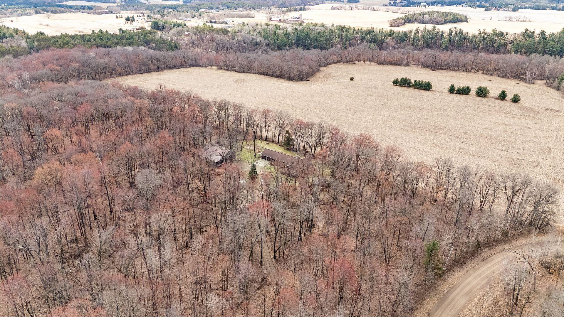 A serene, wooded setting with mature trees throughout.