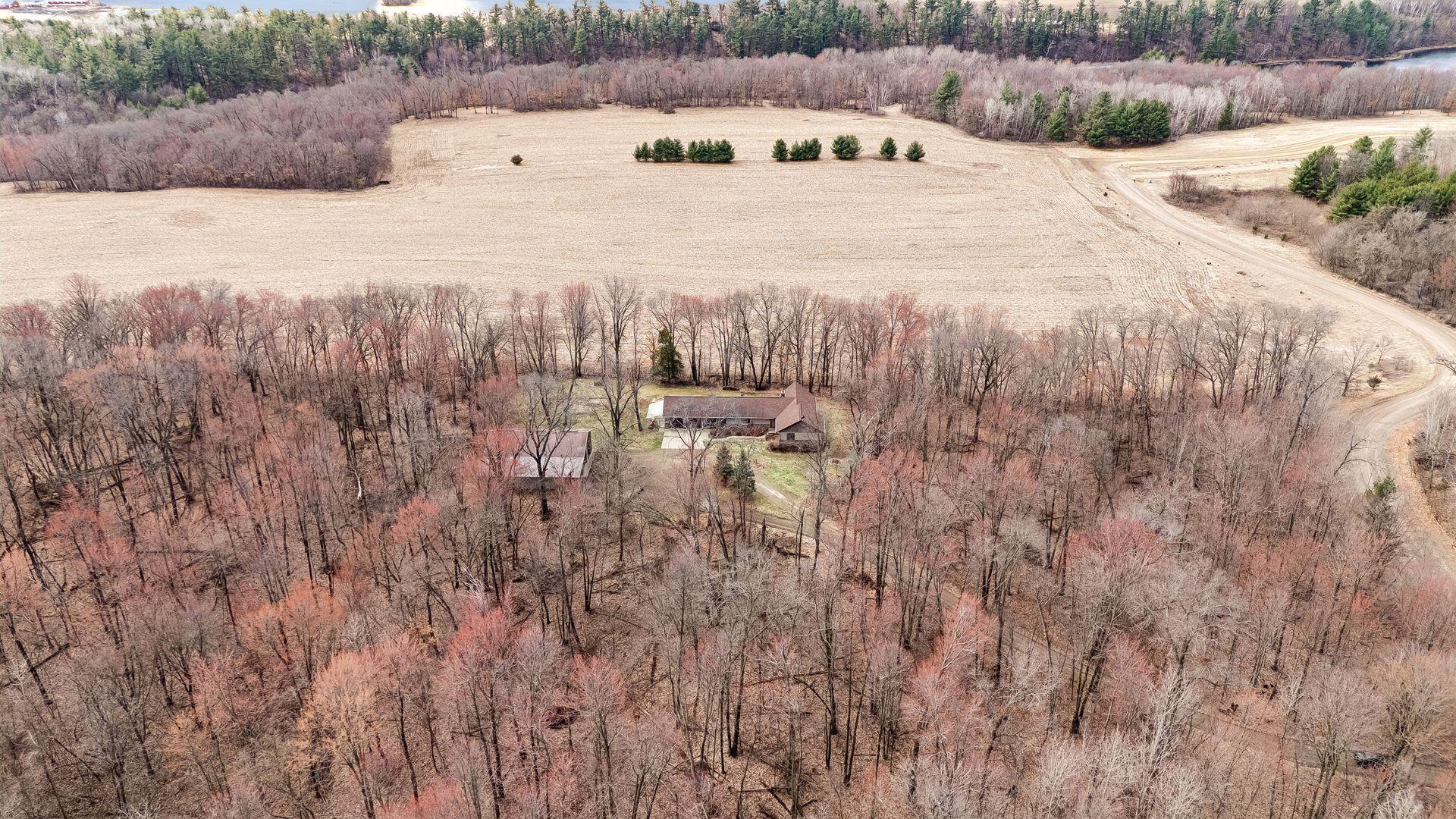 Aerial view showcasing the wooded acreage and ultimate privacy.