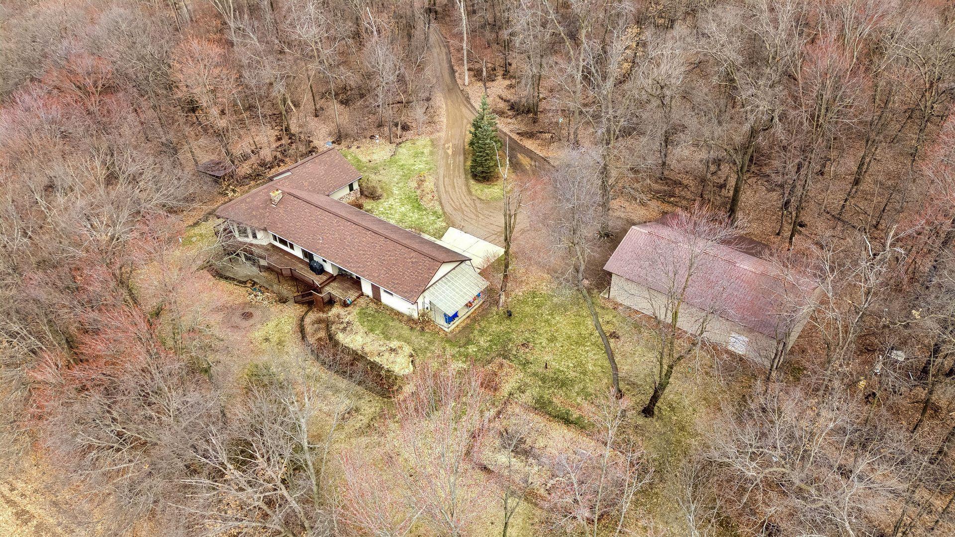 Aerial view of the home, backyard, pole barn, and wraparound driveway.