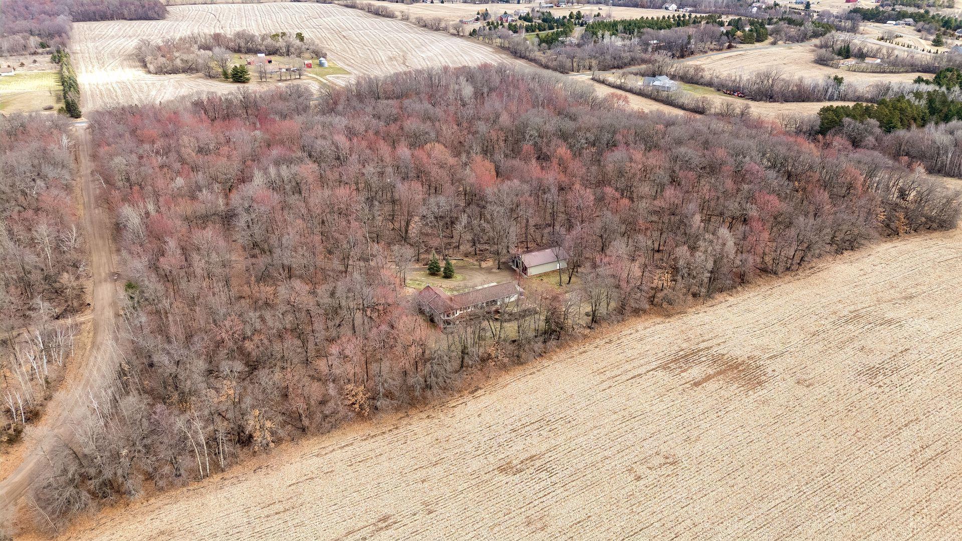 A tranquil aerial view showcasing the heavily wooded acreage.