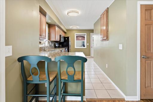 Kitchen layout features a convenient breakfast bar for casual dining and a pantry for convenient storage.