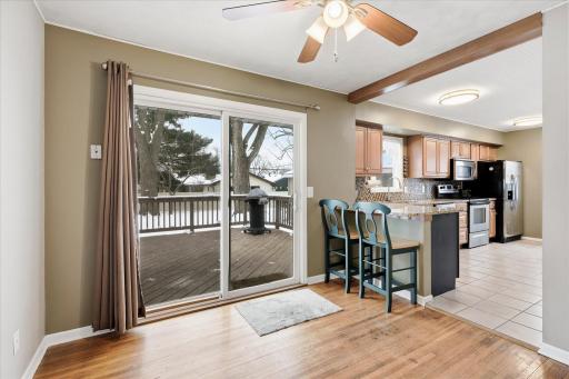 Bright dining space with sliding glass door providing natural light and direct access to the backyard deck, perfect for grilling and outdoor gatherings.