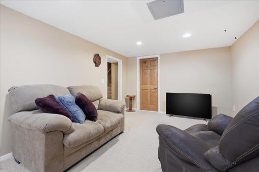 Reverse angle of the lower level highlighting the open layout and natural flow between living, storage, and utility areas.