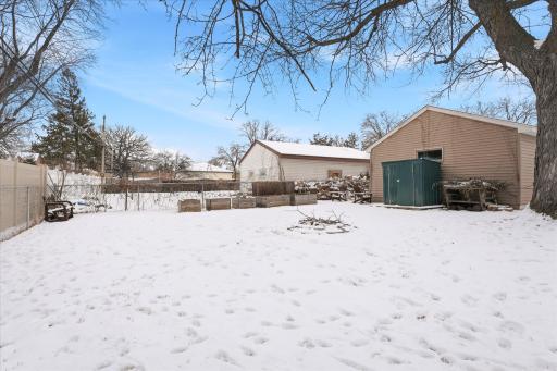 Additional outdoor space, raised garden beds, storage shed, and fire pit area.