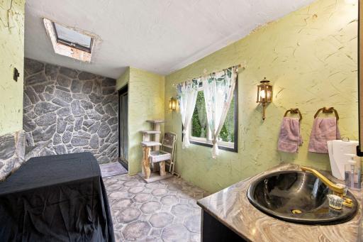 Upstairs primary suite with separate shower and soaking tub.