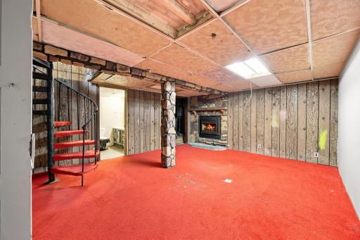 Lower level family room with spiral stairs up to great room