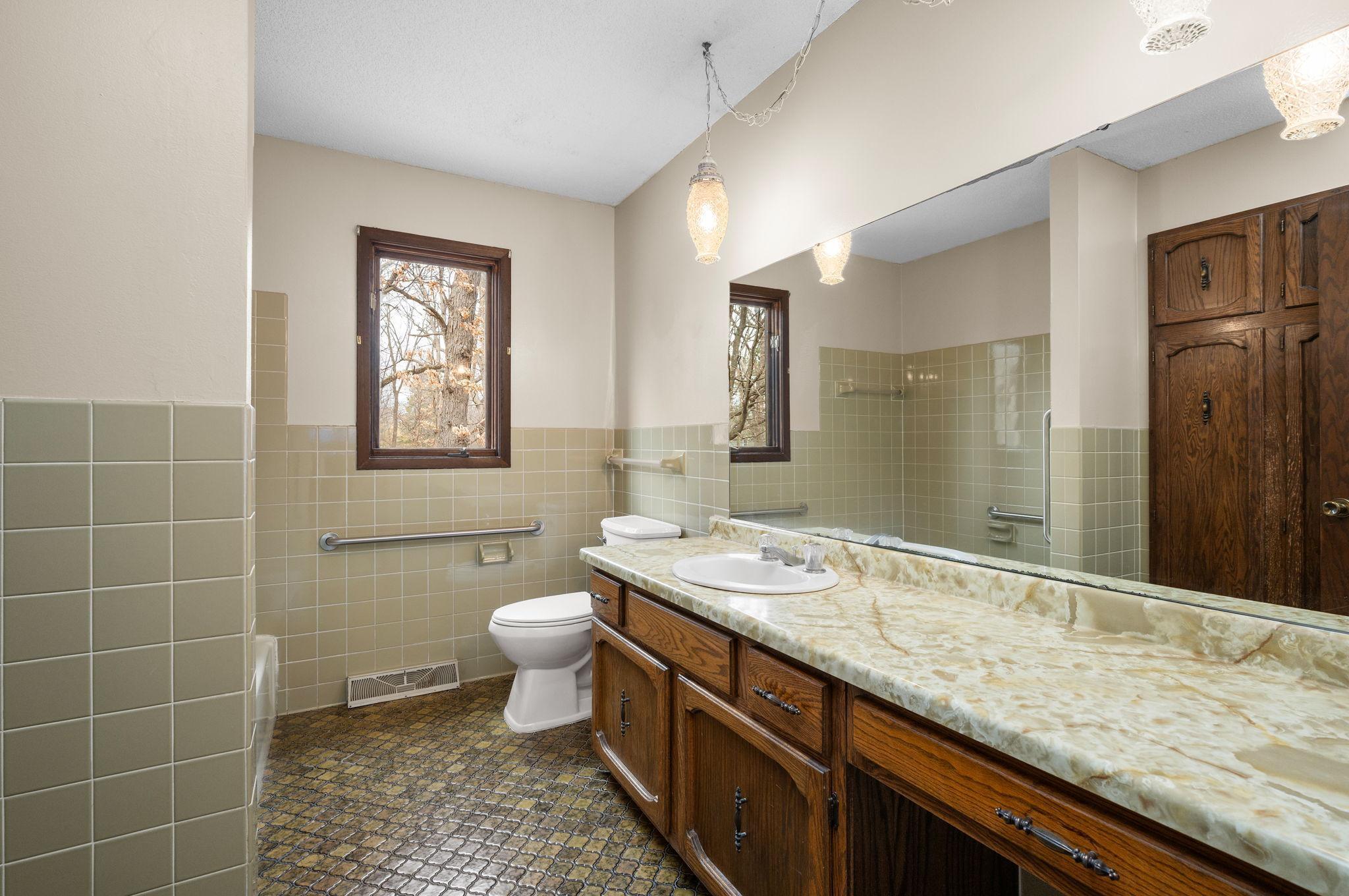 Full Bathroom upstairs with tile surround large vanity and double linen closet