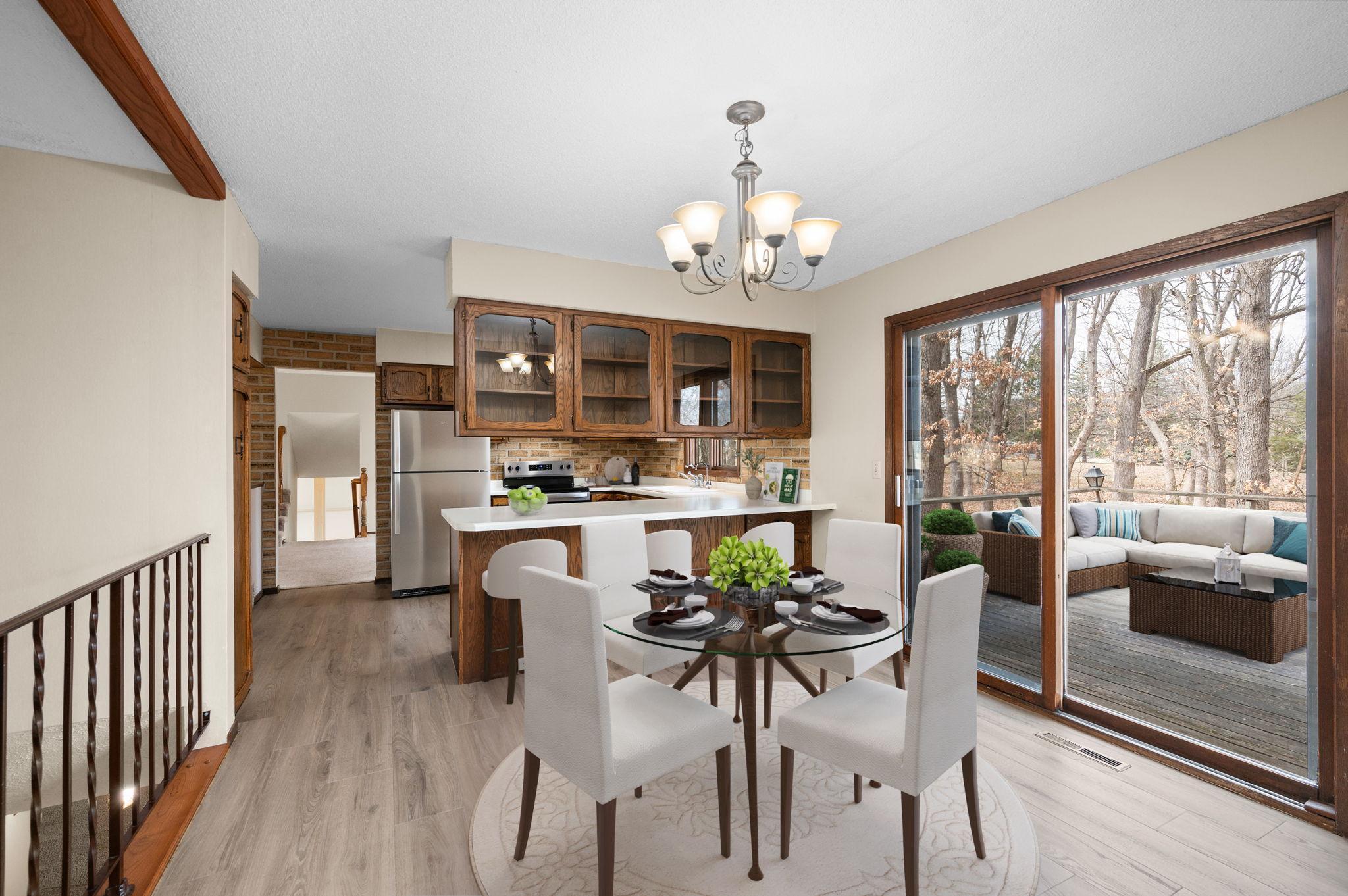 Kitchen has new flooring and new stainless steel appliances and a breakfast bar with informal dining room and access to huge wrap-around deck