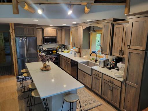 remodeled kitchen- island, cabinetry, & stainless appliances