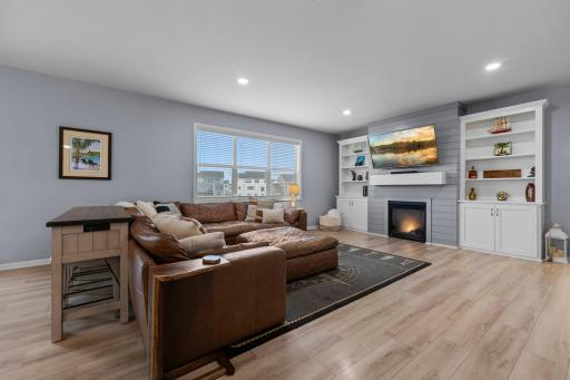 Gas fireplace with built-ins, tinted windows, custom window treatments, knockdown ceilings, new flooring, sunset views, electrical outlet in mantel