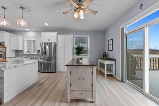 Informal dining with ceiling fan and window. Upgraded cabinet space for additional storage space.