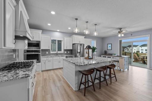 Gourmet kitchen with shiplap surround on island, extra outlets, fixtures, and new flooring.