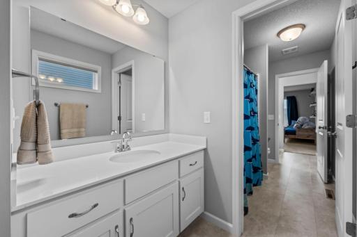 Jack and Jill Bathroom with Corian Countertops, slow close drawers, window, LVT