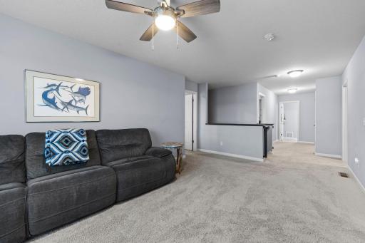 Upper-level loft off of the stairway between owner's suite and secondary bedrooms with a backyard view!