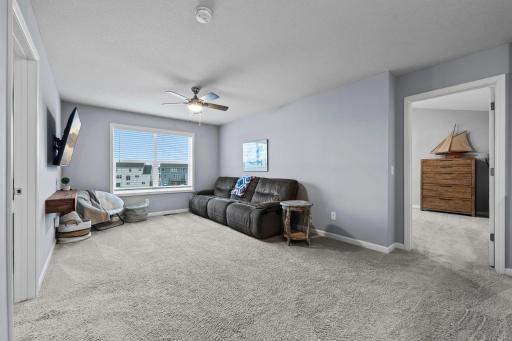 Upper-level loft off the stairway between owner's suite and secondary bedrooms with backyard view!