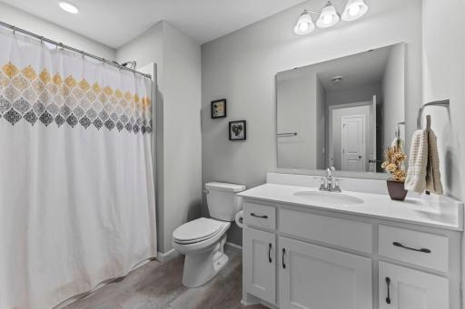 LVT flooring with Corian countertops, soft close drawers, & 3/4 walk-in shower