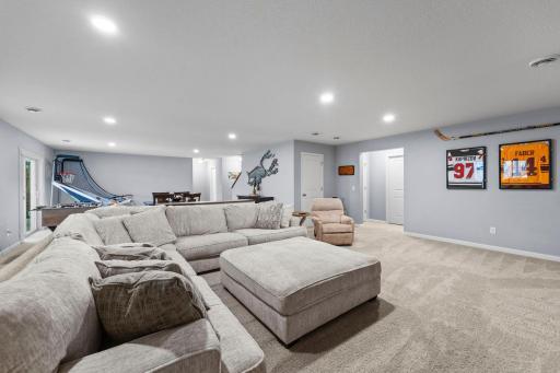 Large spacious family room with recessed lighting, knockdown ceiling (throughout), walkout door to backyard, & tinted windows