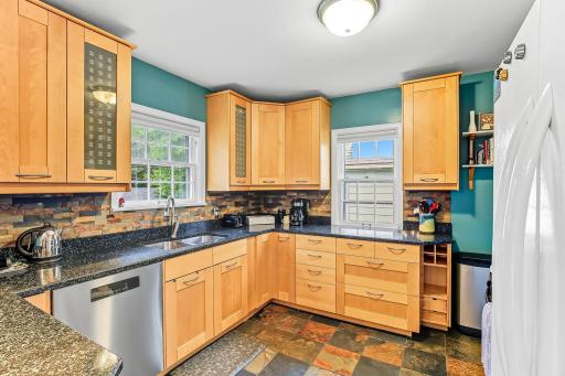 Kitchen has lots of storage and stone countertops