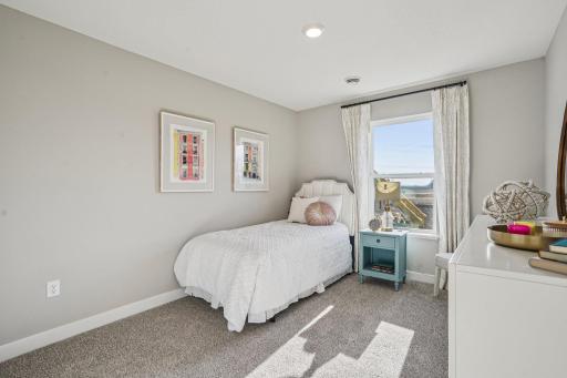 Three secondary bedrooms ideal for guests, office, or hobbies. Model photos. Options and colors may vary.