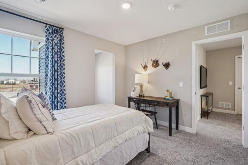Three secondary bedrooms ideal for guests, office, or hobbies. Model photos. Options and colors may vary.