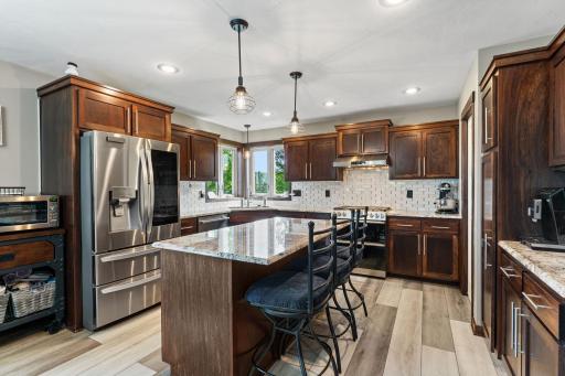 Gorgeous kitchen! Beautiful floors! Granite countertops, modern tiled backsplash and Stainess Steel appliances!