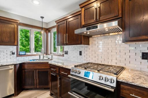 Stylish tiled backsplash. Stainless Steel, gas range. Corner windows brings in a ton of natural light.