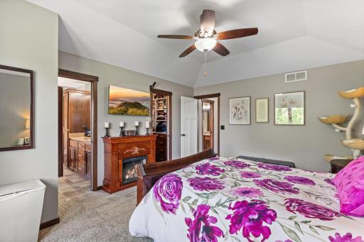 Primary features a private bathroom and walk in closet with custom shelving / drawers.